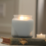 soy wax candle sitting on a book