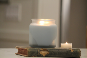 soy wax candle sitting on a book