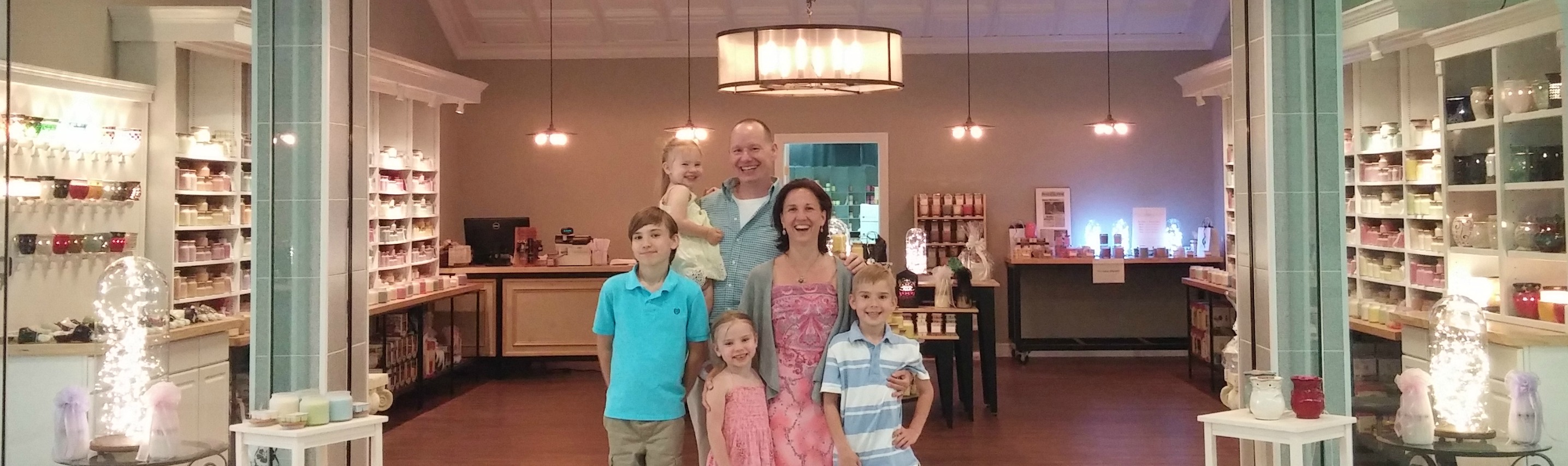 family-in-front-of-candle-store